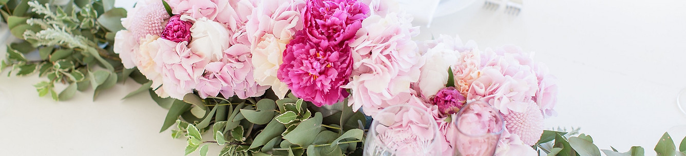 Floral centrepiece with pink peonies and greenery