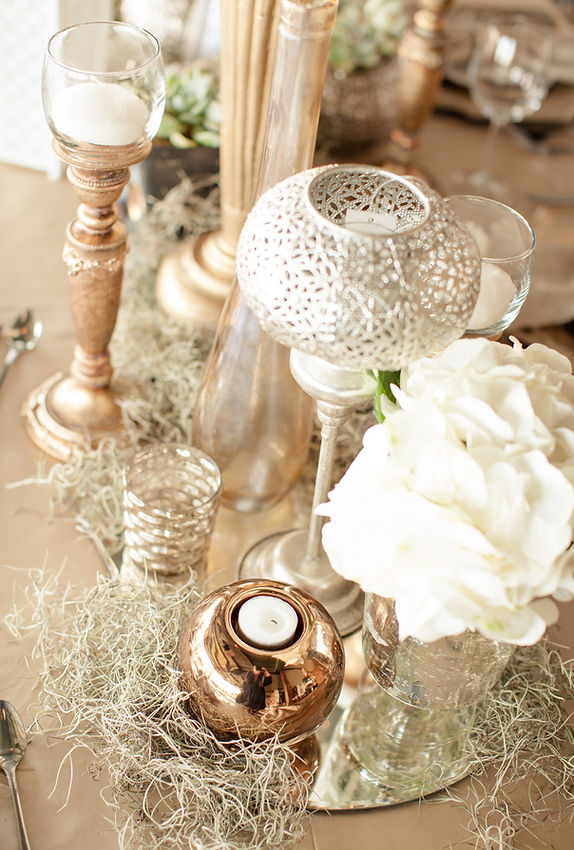 Decorative table centrepieces with candles and flowers