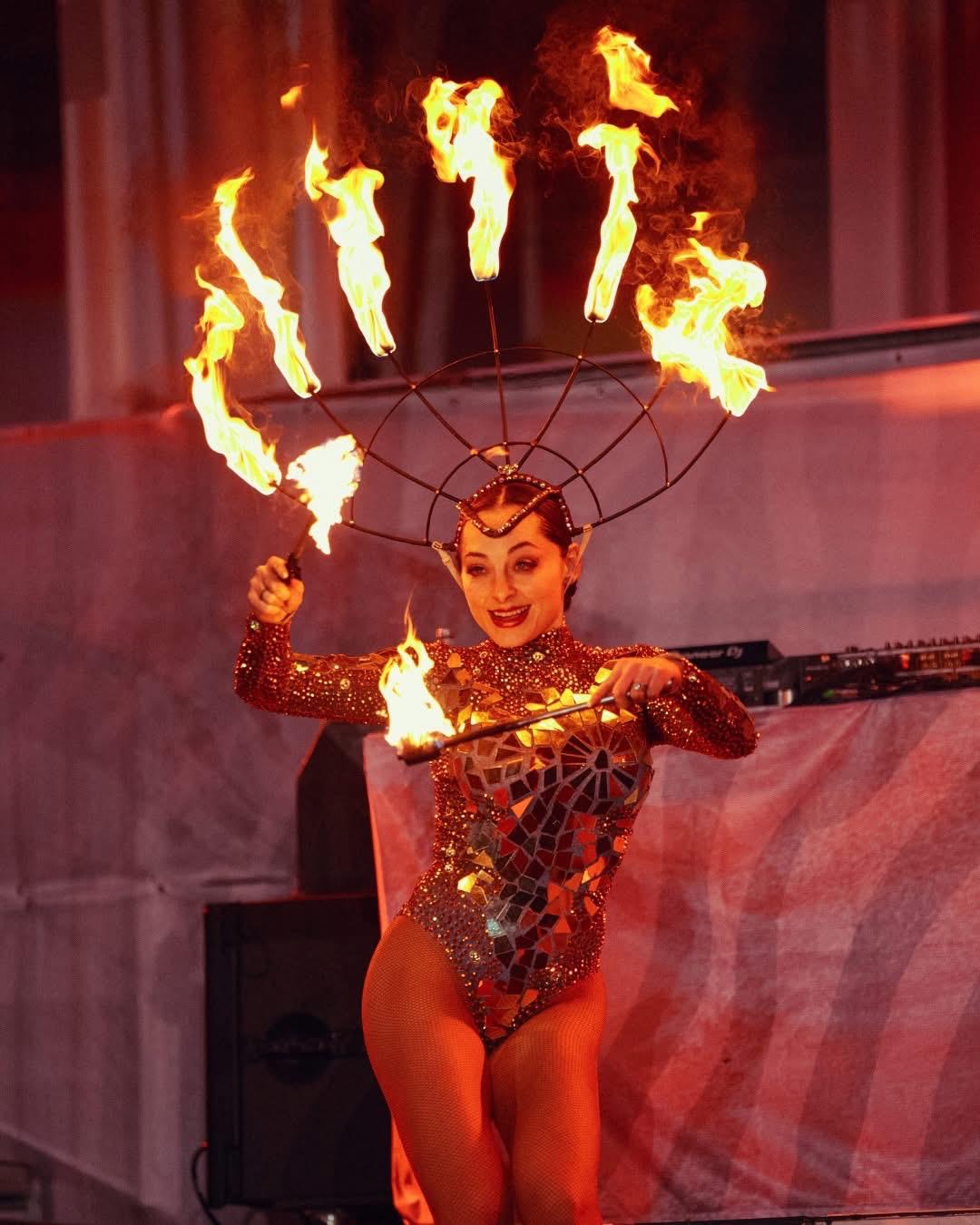 Fire performer showcasing a fire dance with flaming props