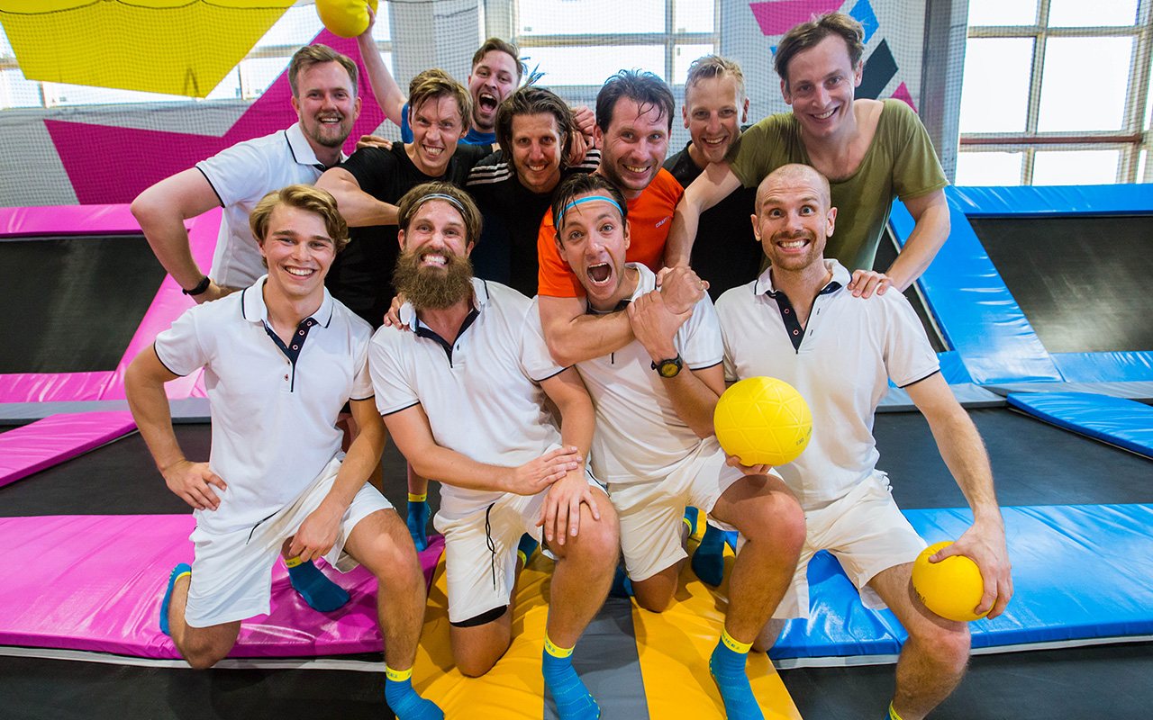 Group of team members posing on trampolines at BOUNCE Inc