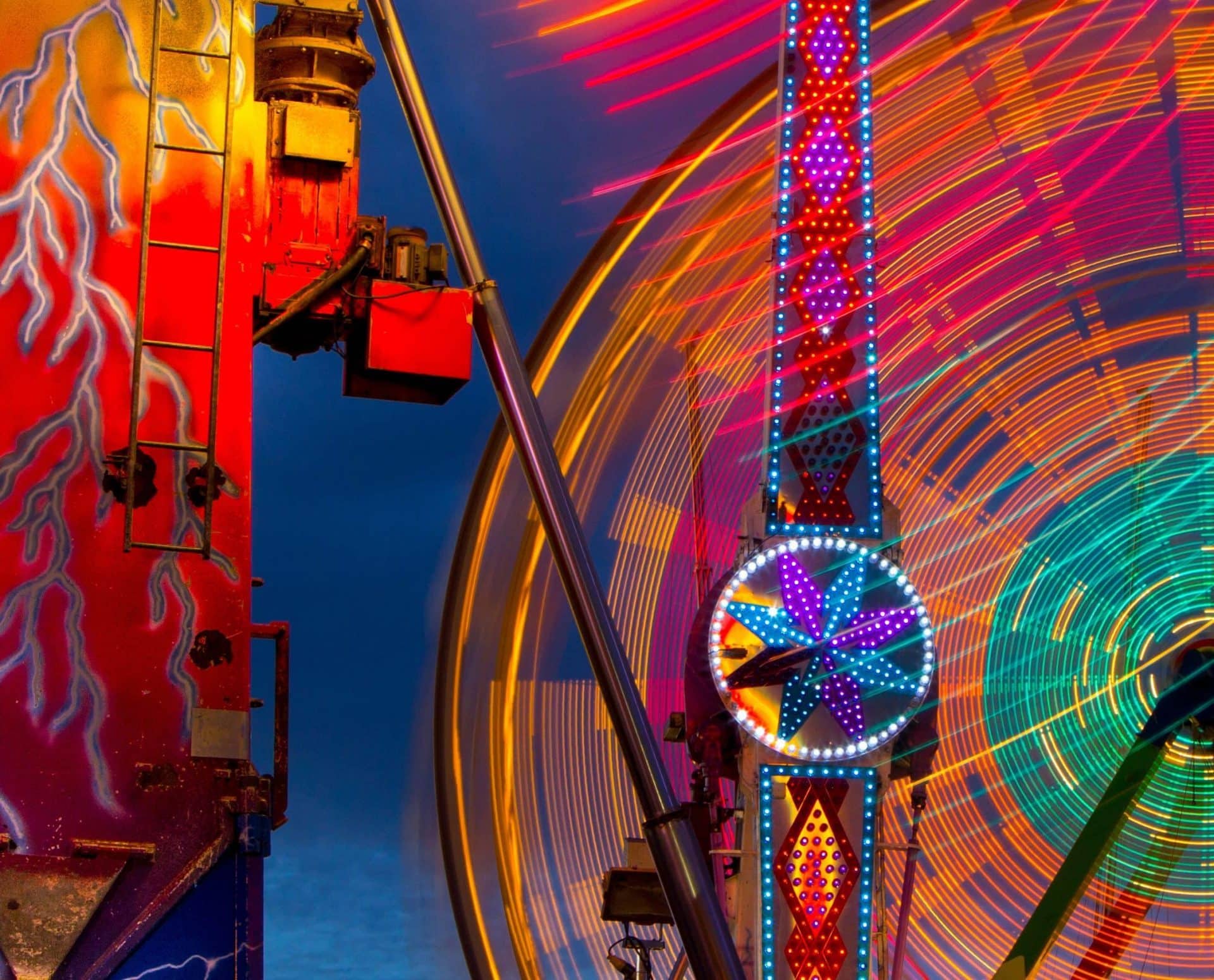 Colorful carnival rides with illuminated lights and motion