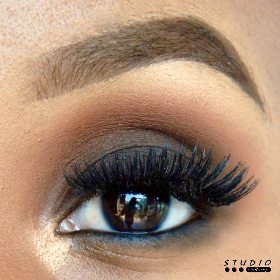 Close-up of an eye with detailed makeup and lashes