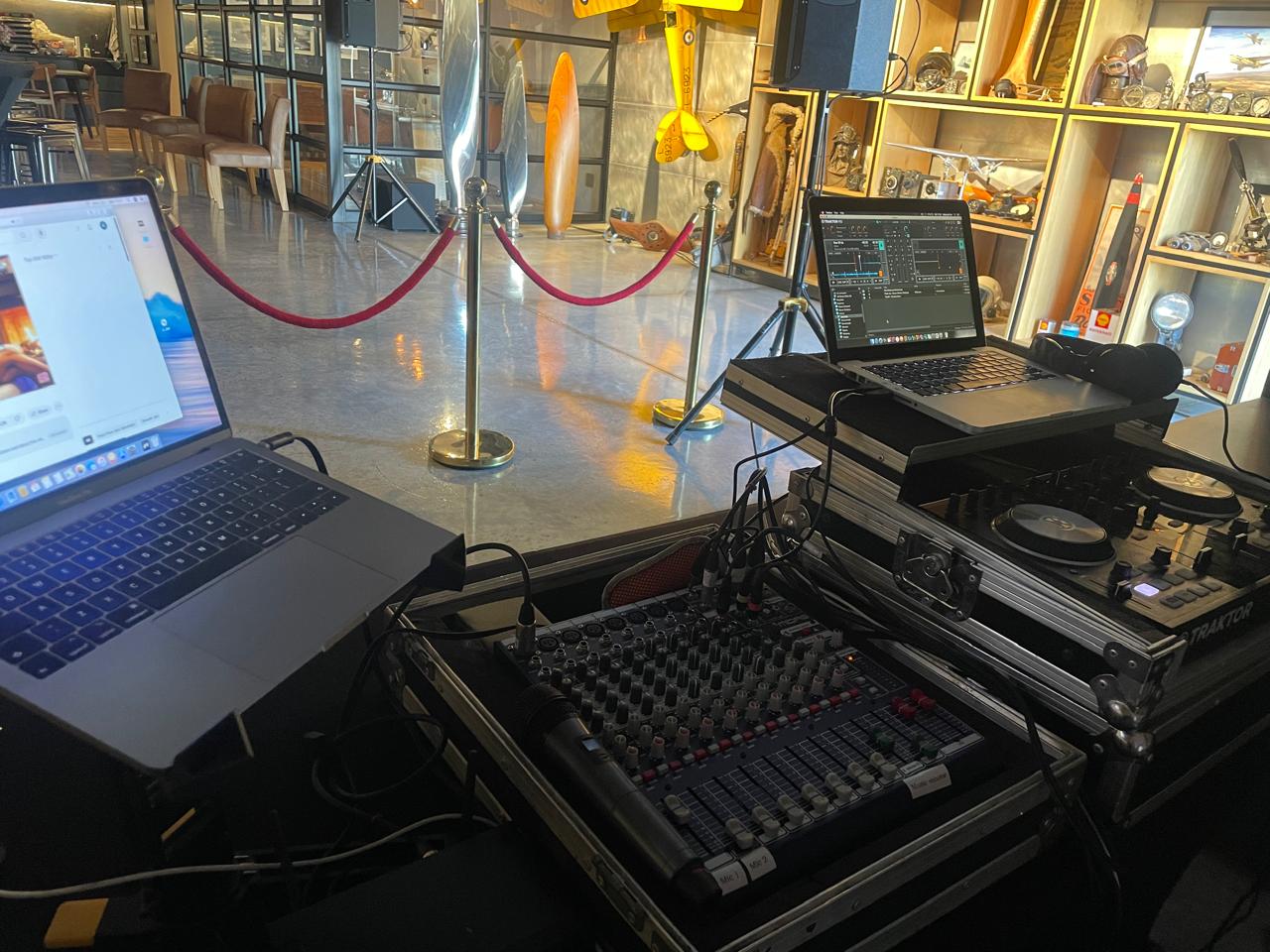 DJ equipment setup with mixers and laptops