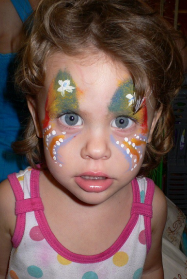 Child with vibrant butterfly face painting