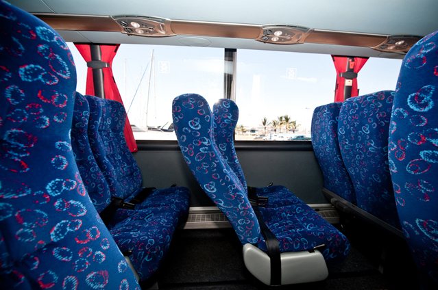 Interior view of a luxury coach with blue patterned seats