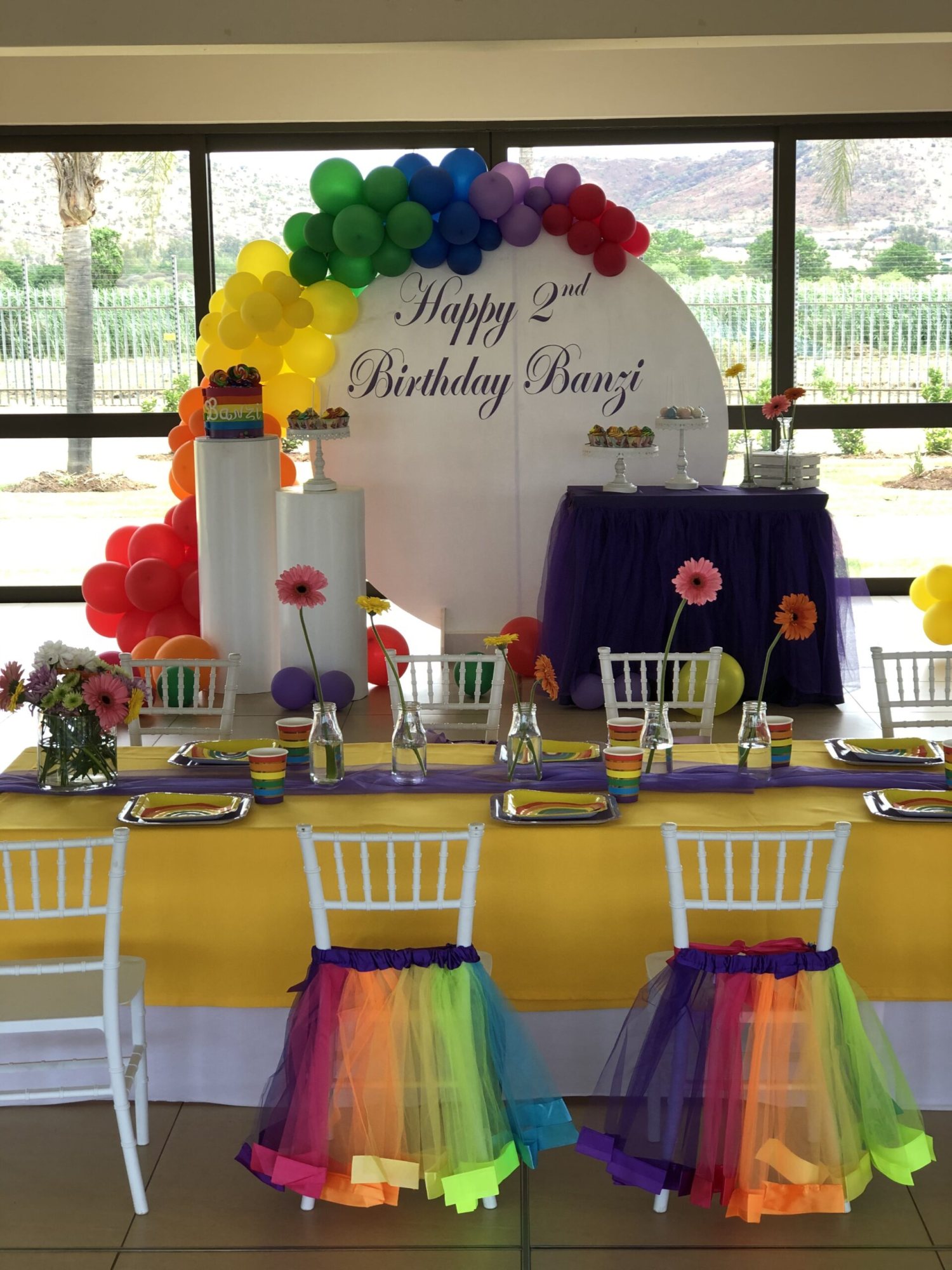 Festive birthday table setup with colorful decorations.