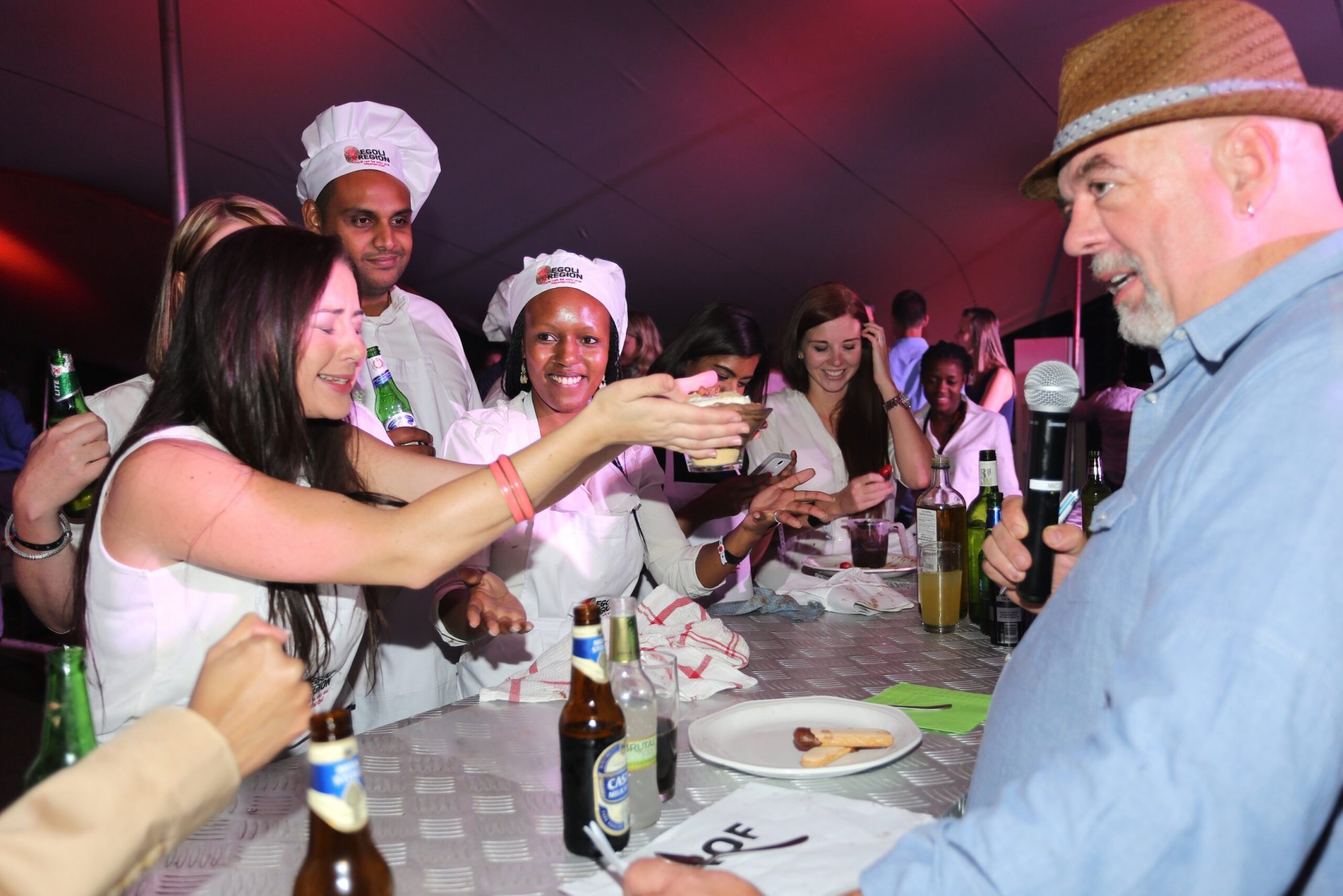 Guests interacting with chefs in a culinary experience