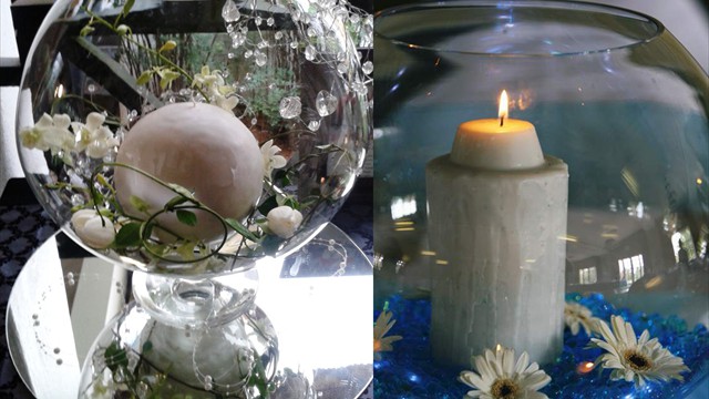 Two elegant candle displays with flowers and crystals.