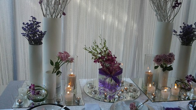 Table decor with candles and flowers in stylish vases