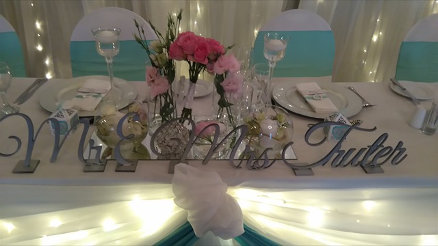 Table setting with floral centerpiece and illuminated drapery