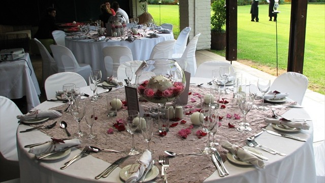 Round table setting with candles and floral arrangements