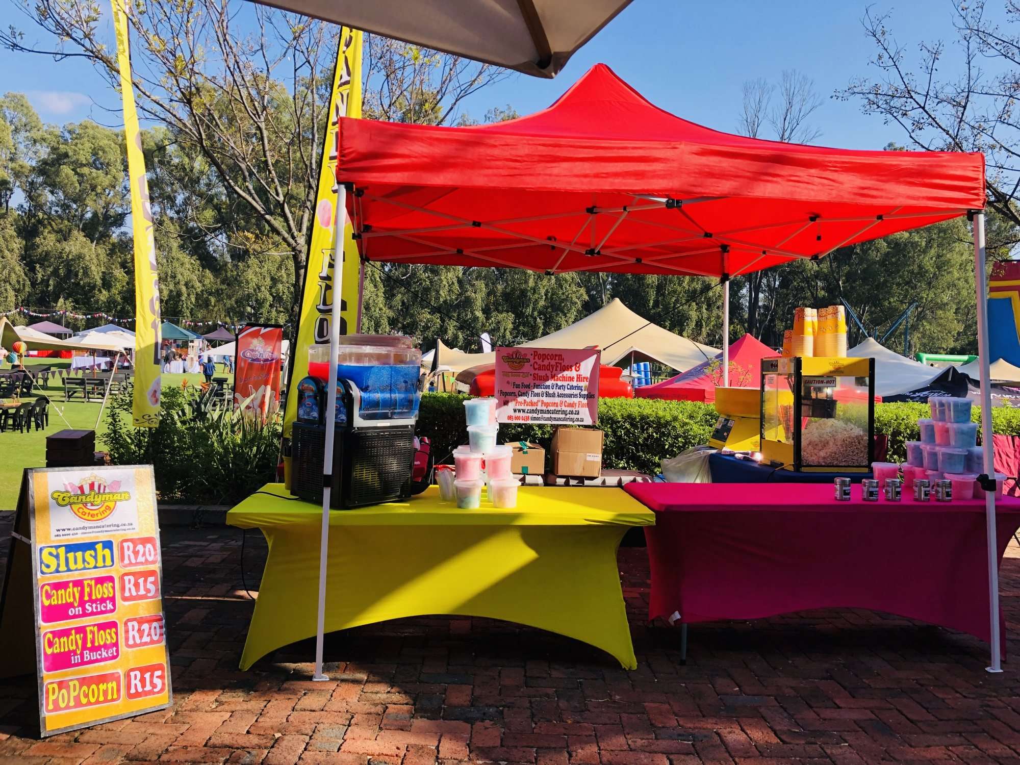 Colourful food station with slushies, candy floss, and popcorn for events