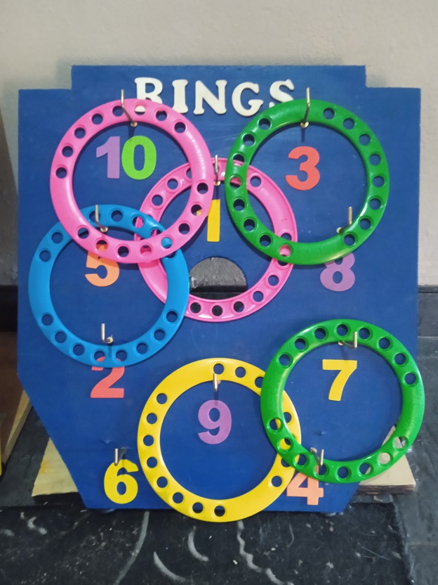 Colorful ring toss game with numbered pegs