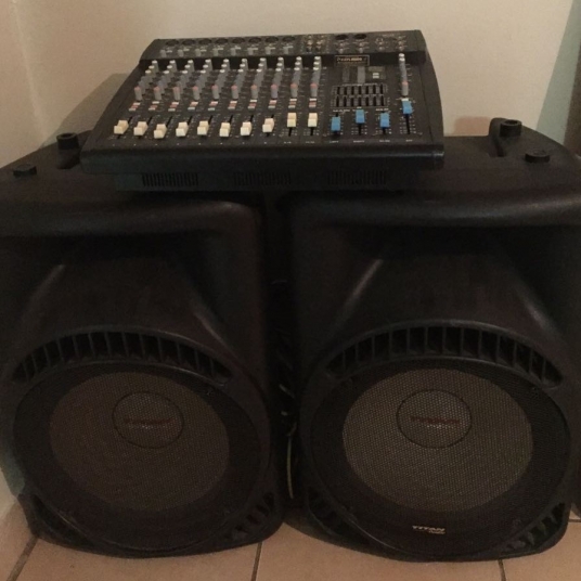 Mixing console on two black speakers