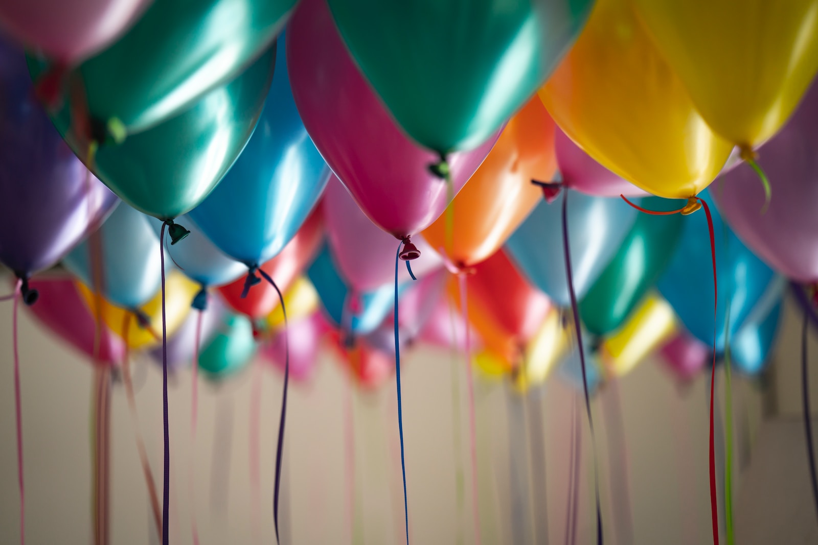 Colorful balloons in various shades hanging from above