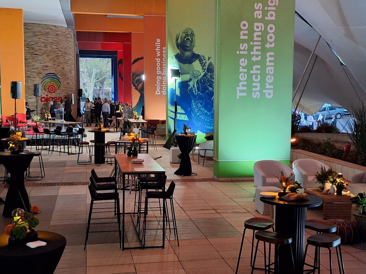 Modern event space with tables and floral decor.