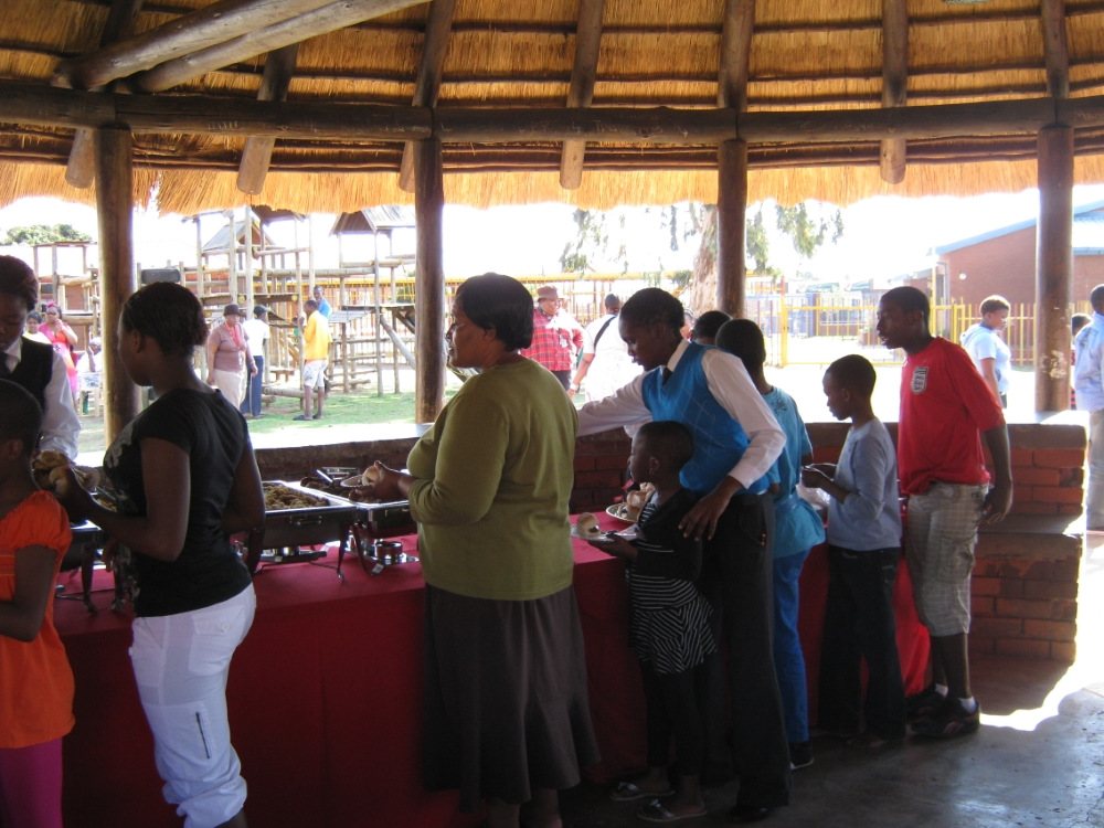 Guests at a buffet table in an outdoor setting
