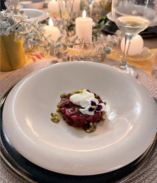 A vibrant vegan beet tartare served in a bowl with garnishes.