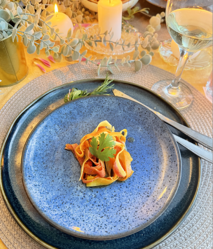 Plate of vegan dish garnished with herbs on a table setting