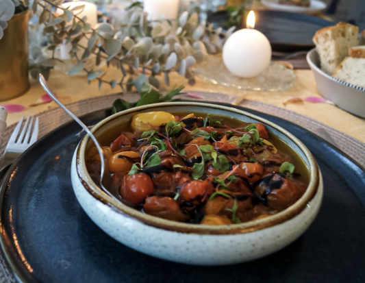 Bowl of roasted cherry tomatoes on a dining table