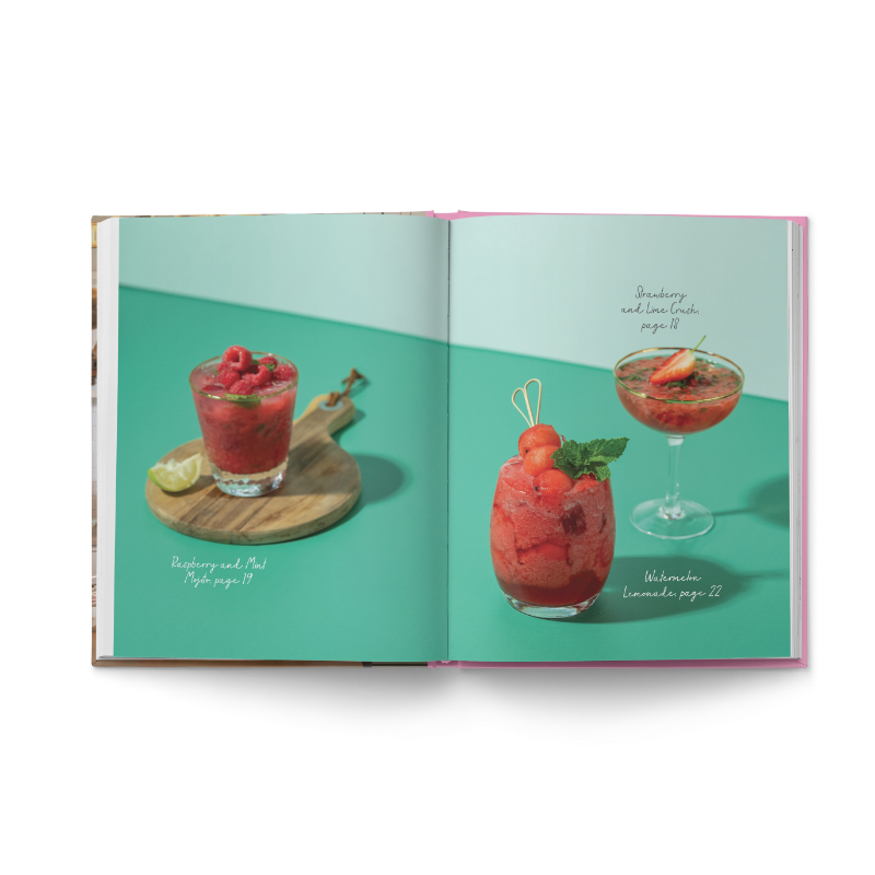 Open recipe book featuring raspberry and watermelon drinks on a teal background