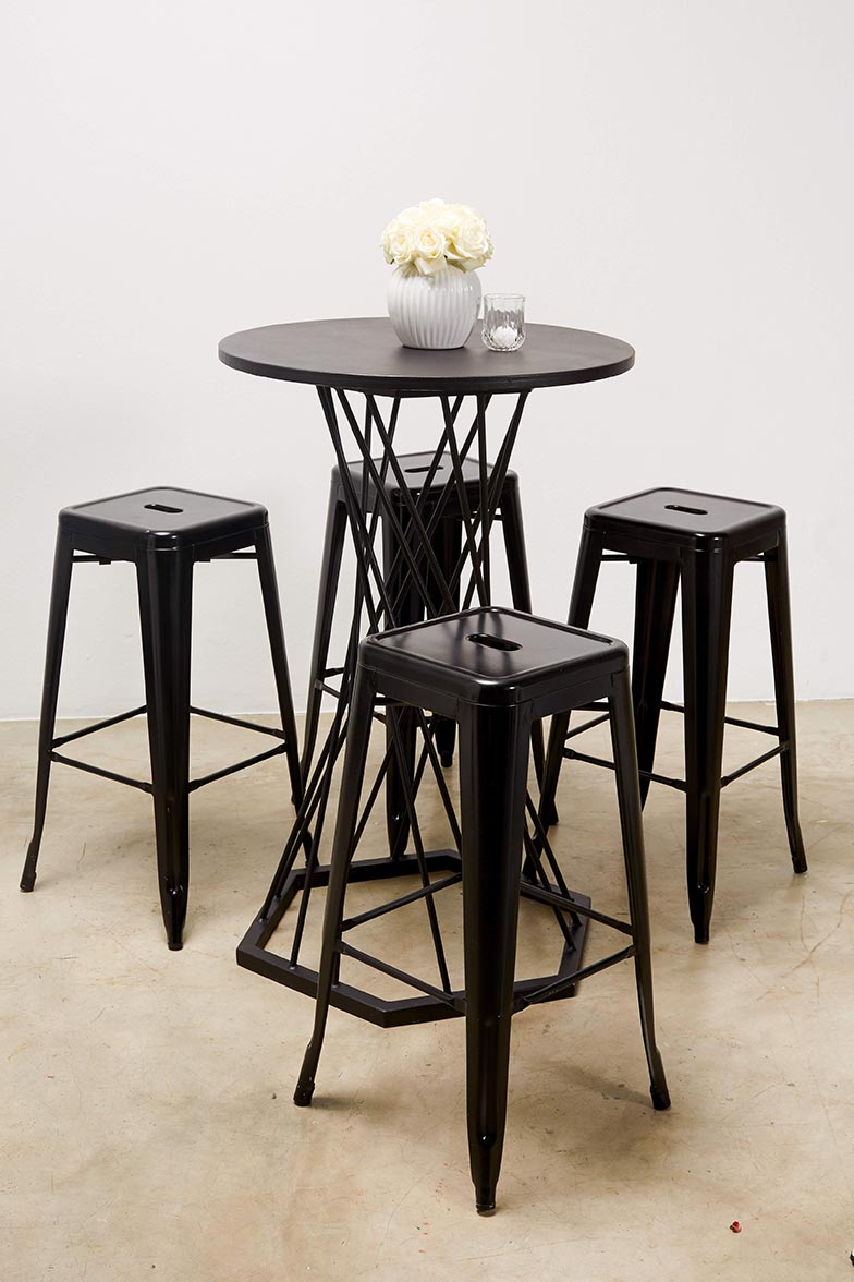 Black cocktail table with matching stools and white roses.