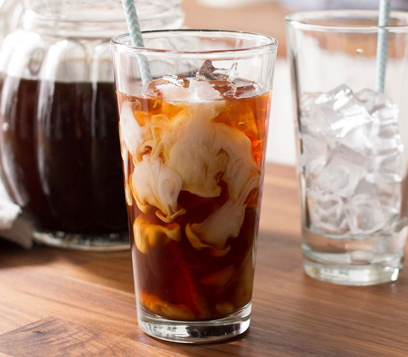 Iced coffee with cream in a tall glass