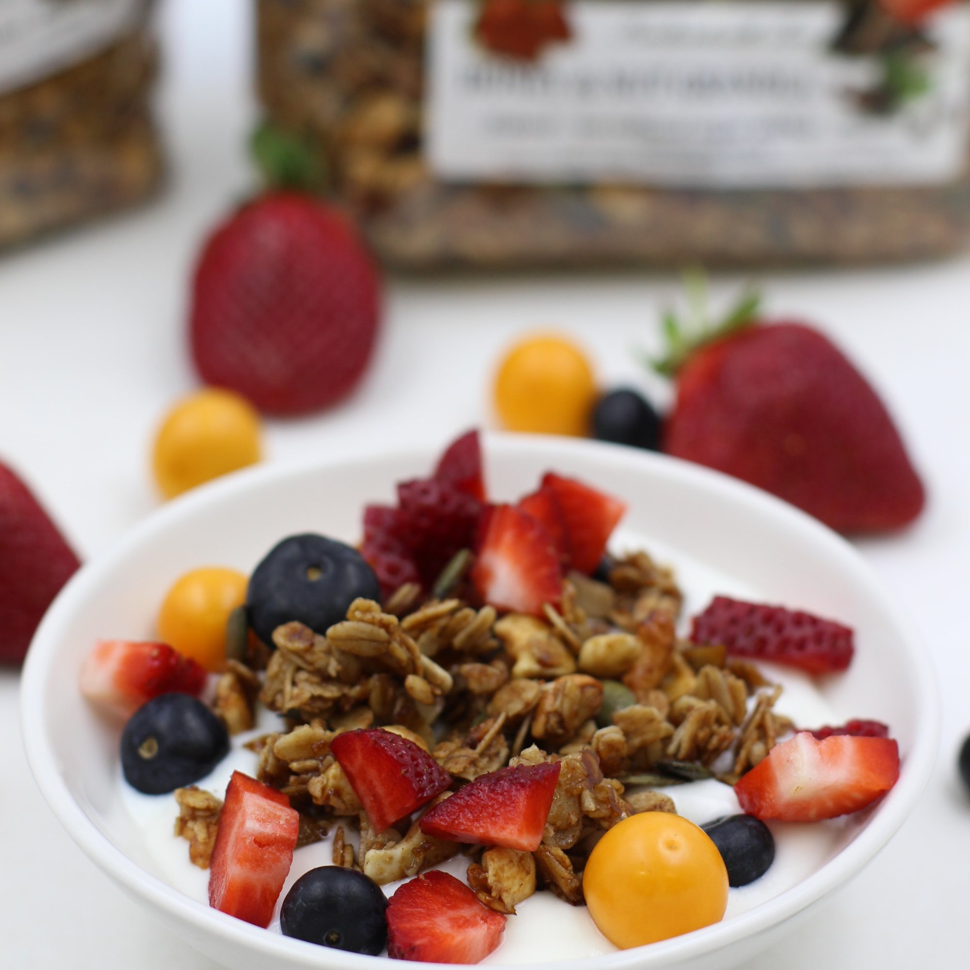 Bowl of yogurt topped with granola and fresh berries