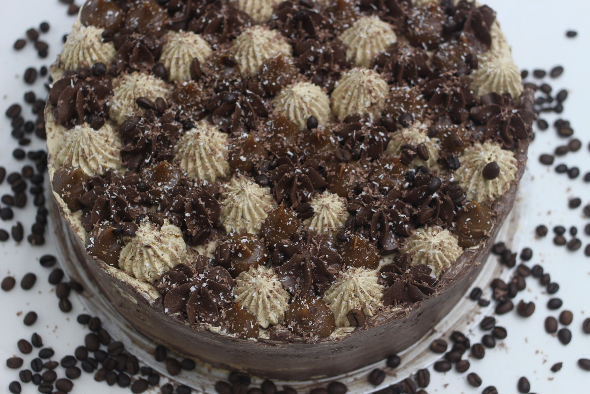 Close-up of a gourmet chocolate cake with coffee and cream toppings