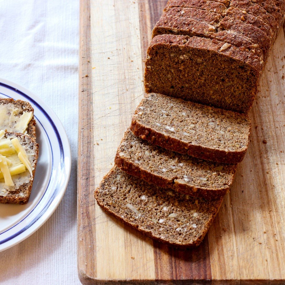 Sliced whole grain bread on a wooden board