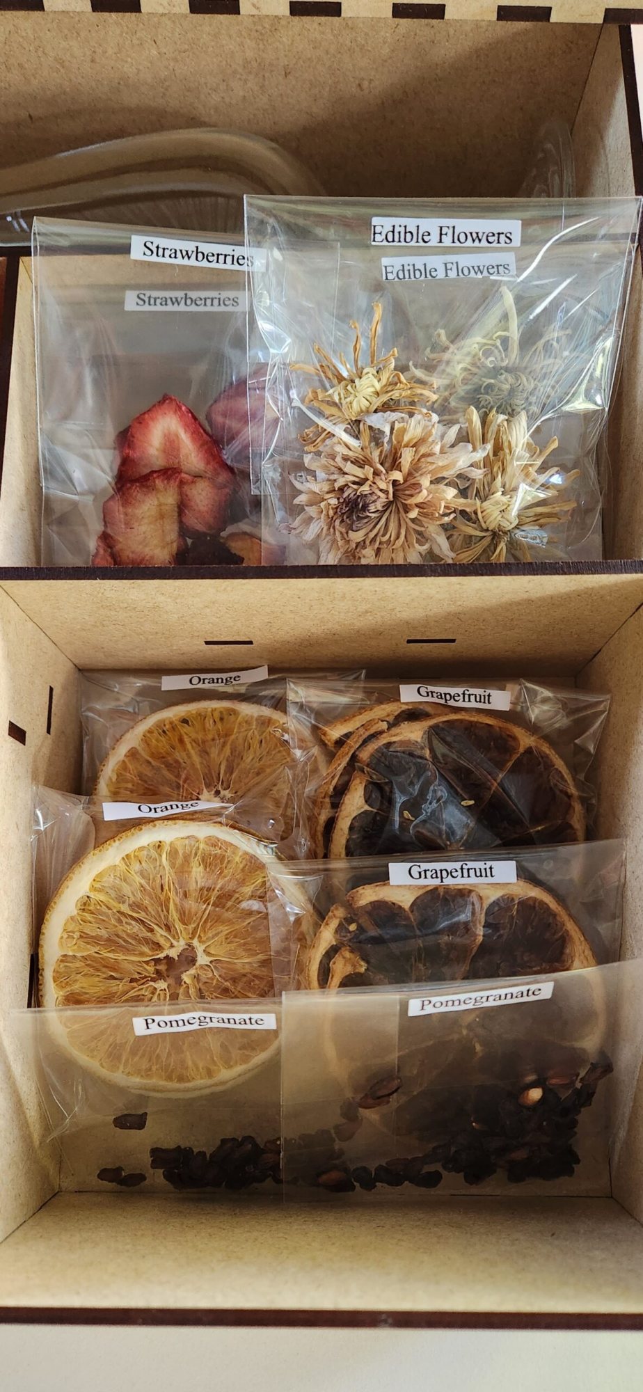 Box containing dried fruit slices and edible flowers.