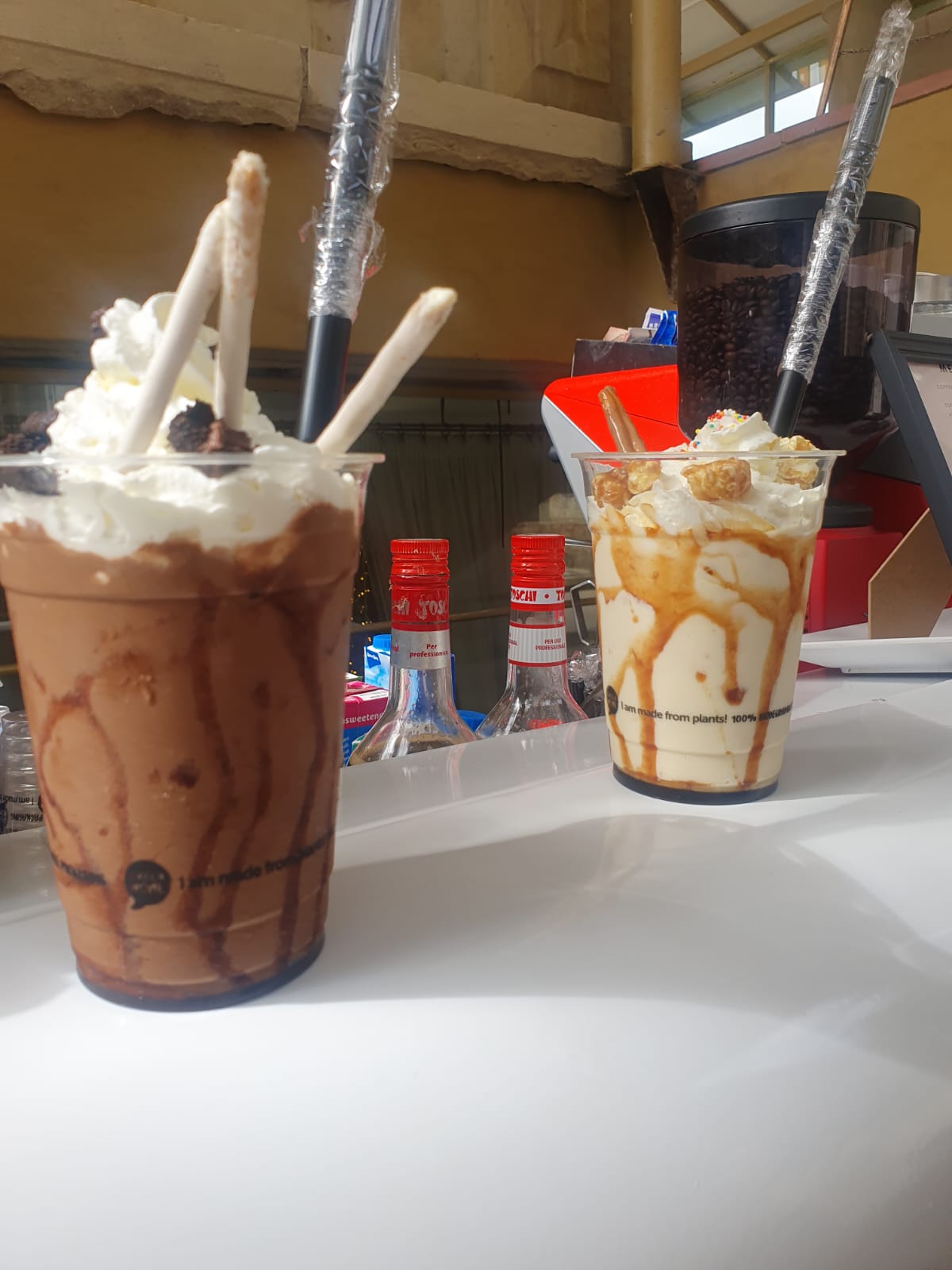 Two slushie cups with toppings and straws