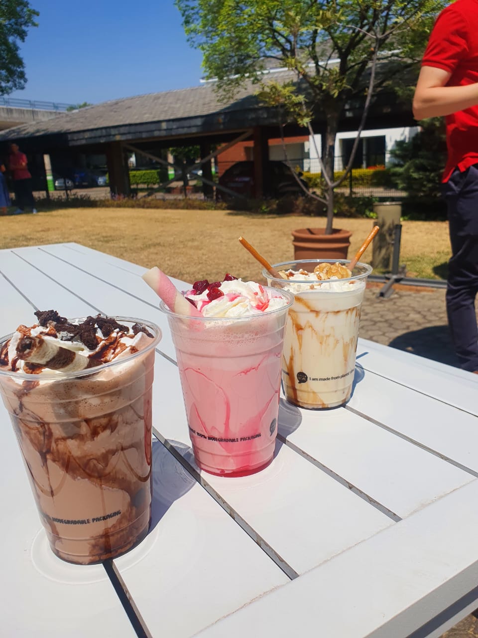 Three bubble tea cups with various toppings on a table