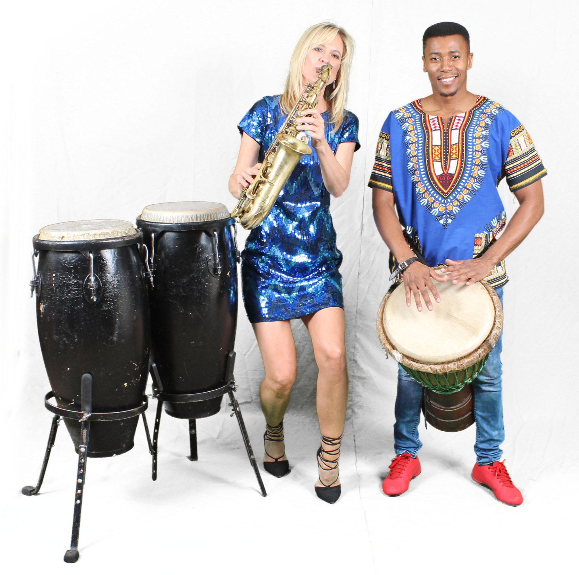 Rike Coetzer playing saxophone with a percussionist and drums