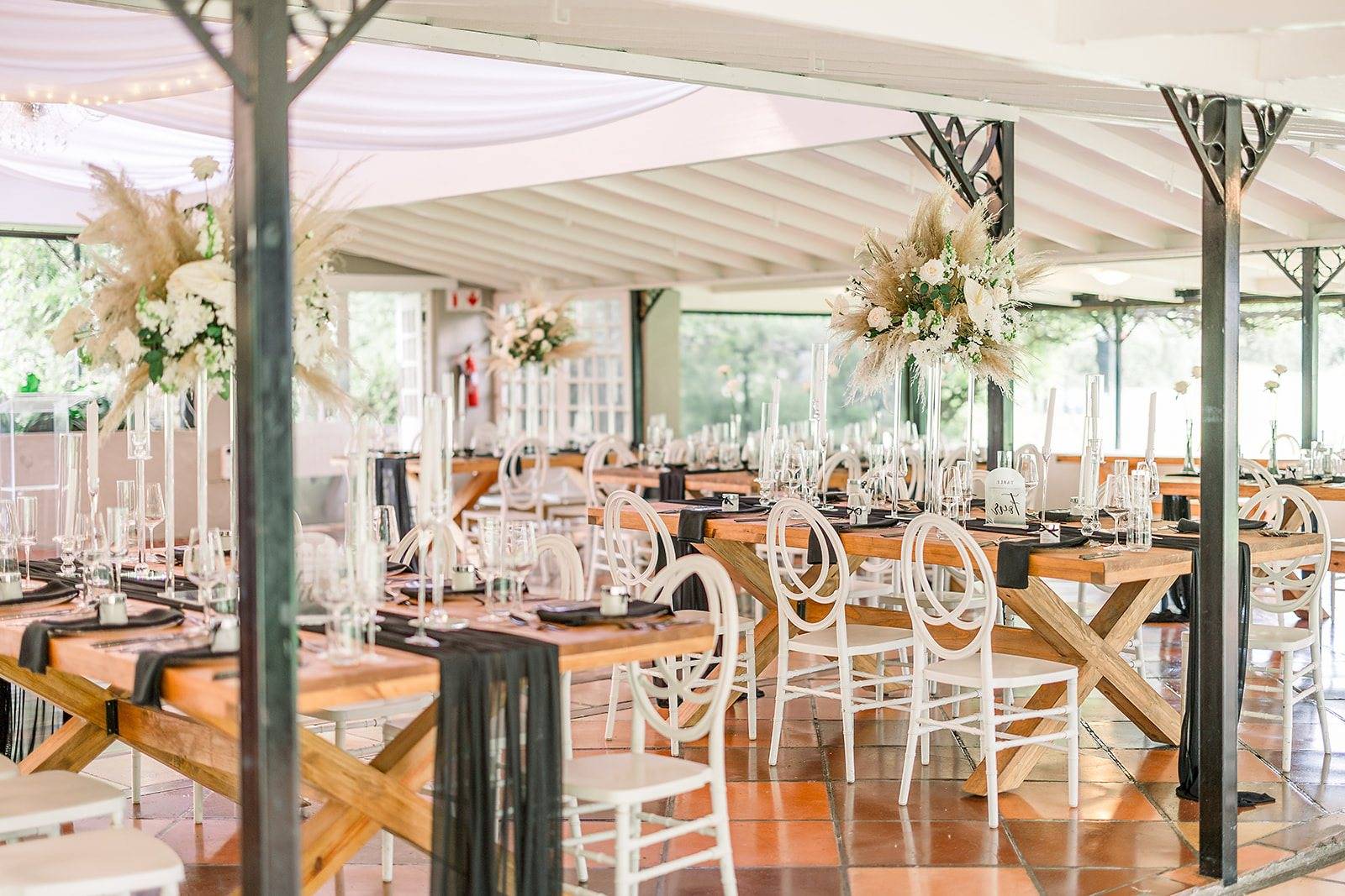 Wedding reception with wooden tables and floral centerpieces