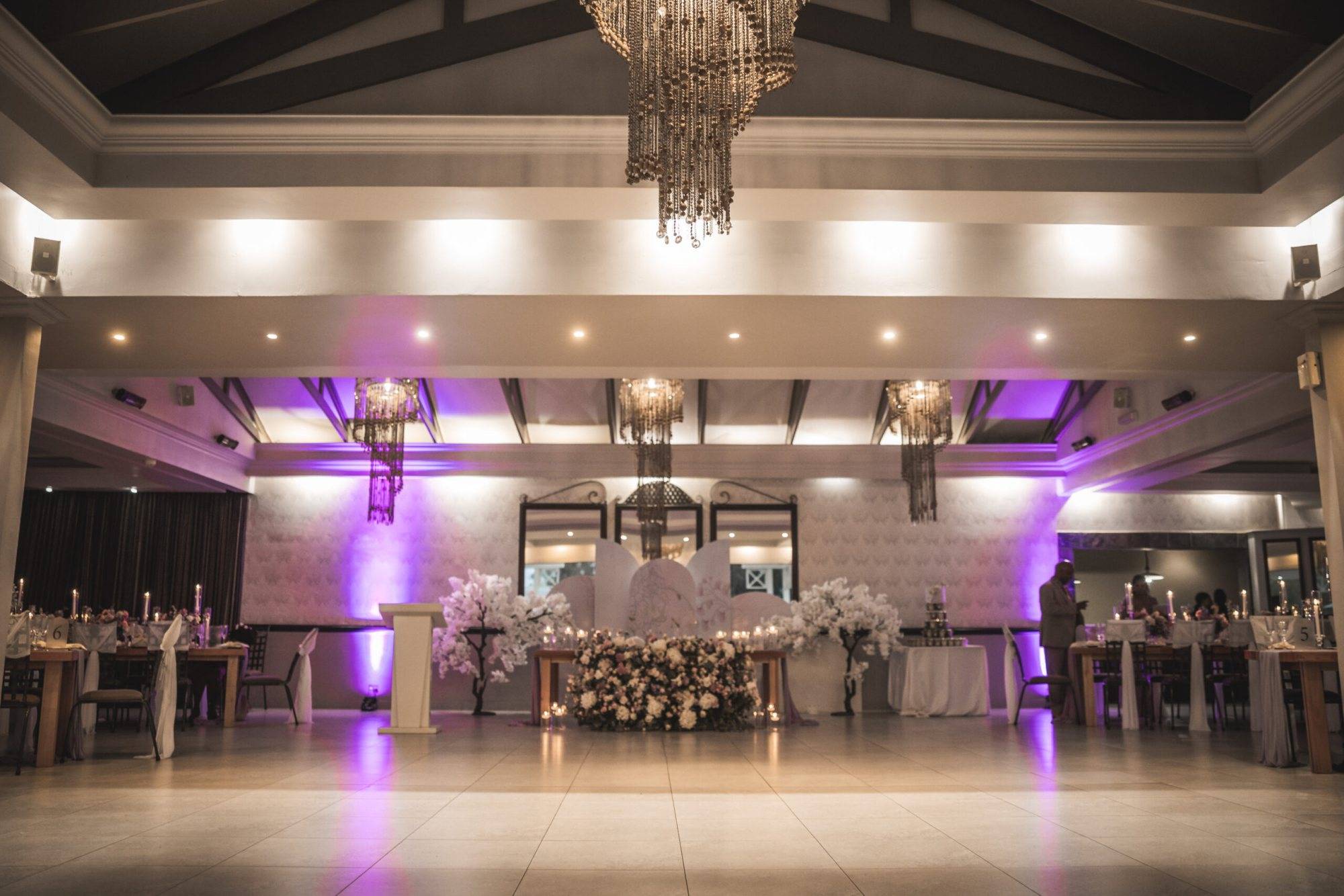 Reception area with floral arrangements and purple lighting