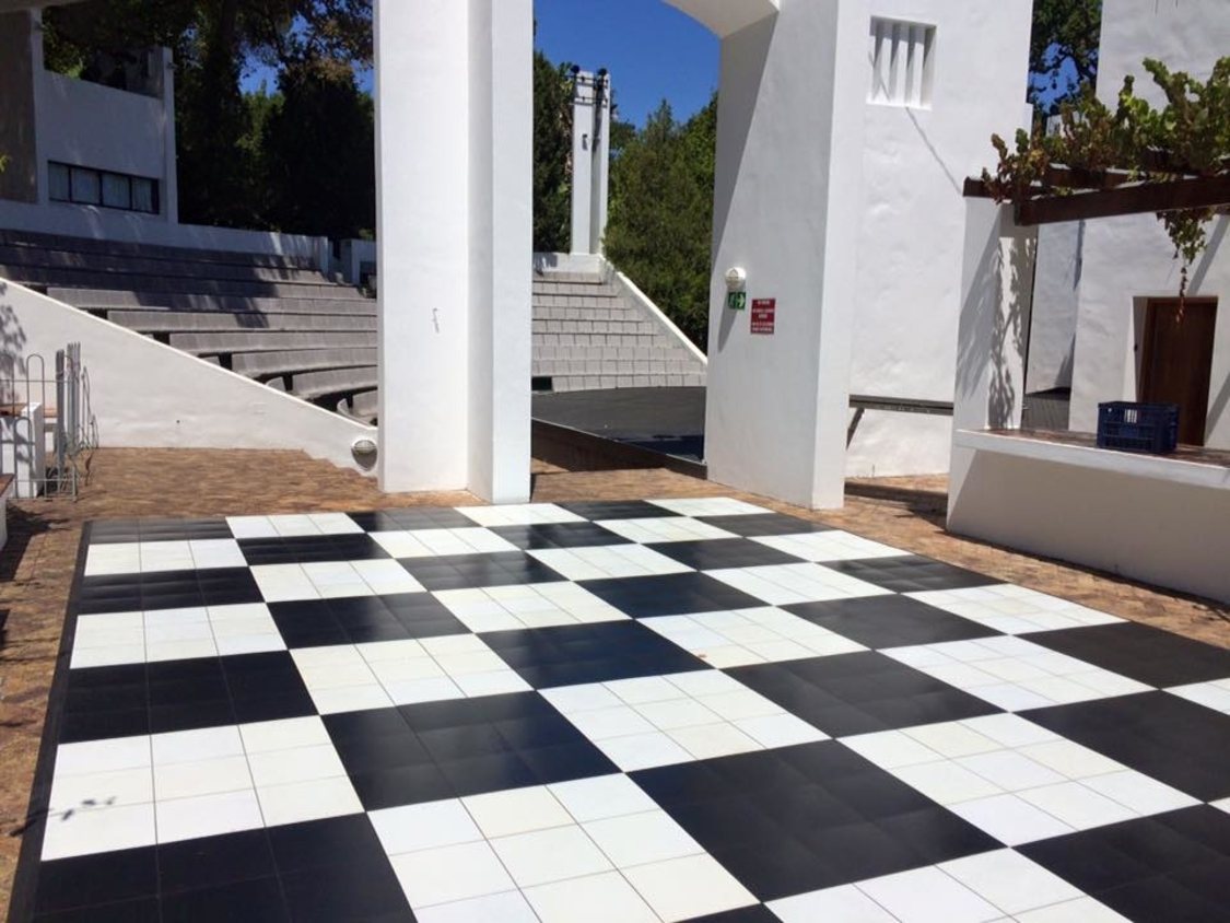 Black and white checkered dance floor in an outdoor space