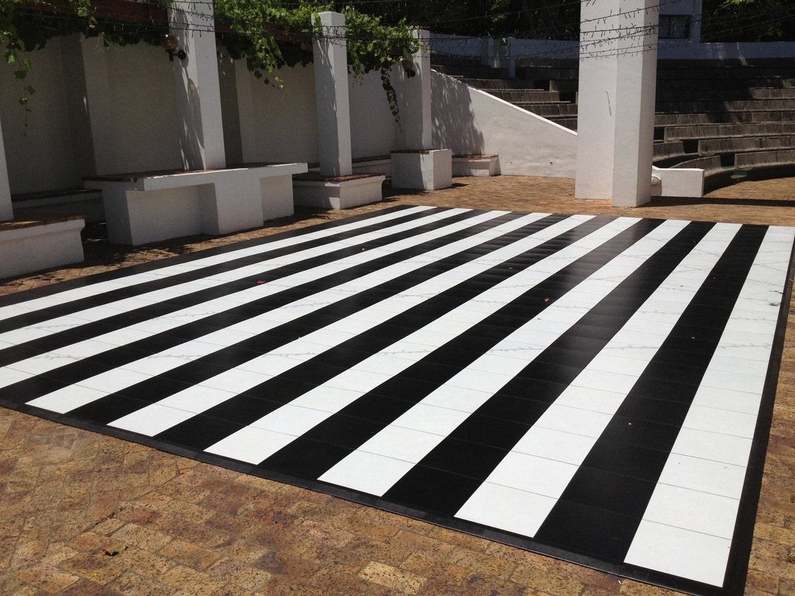 Black and white checkered dance floor in an outdoor space