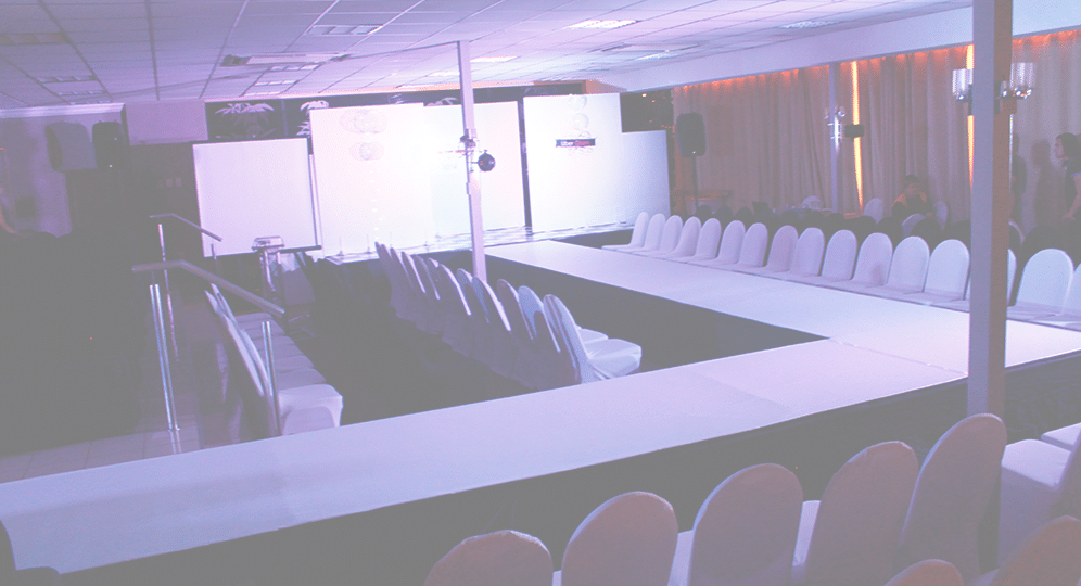 Runway setup with chairs and backdrop in an event space