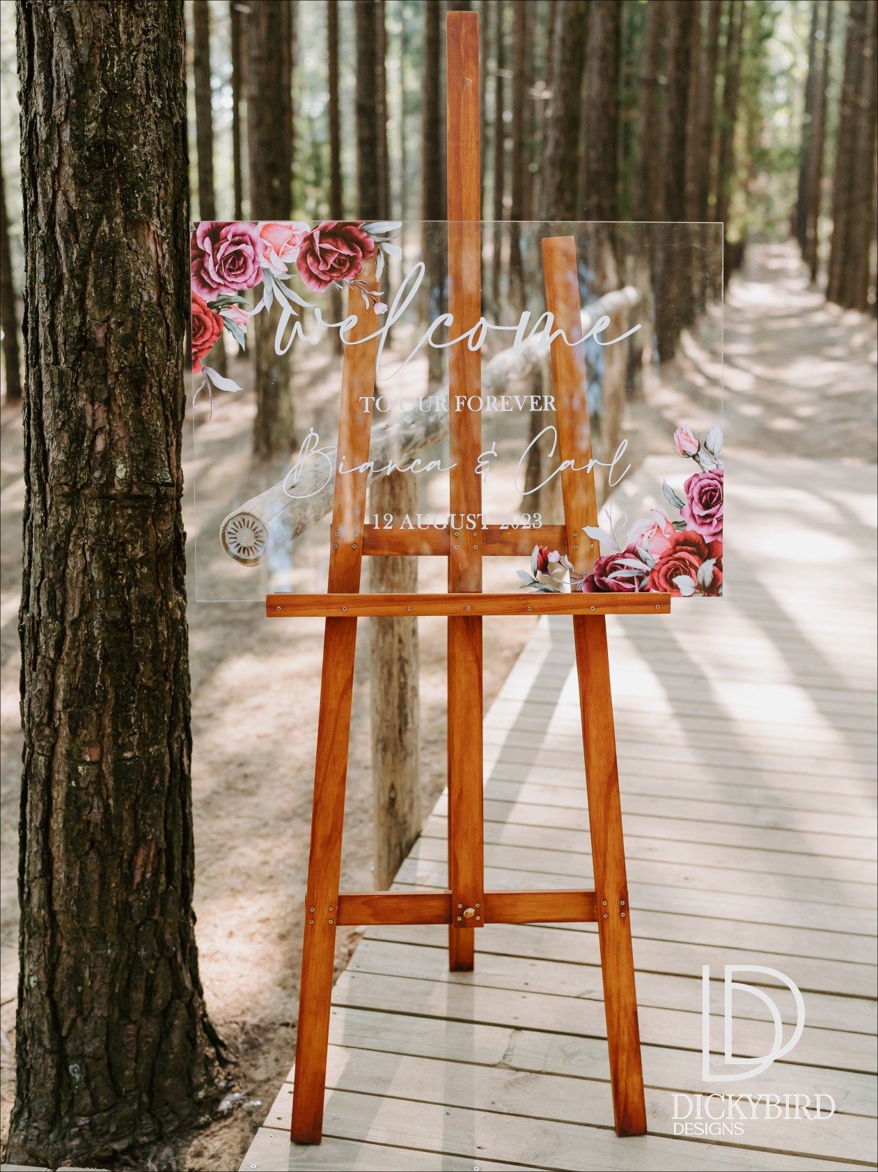 Custom wedding welcome sign with floral elements on display
