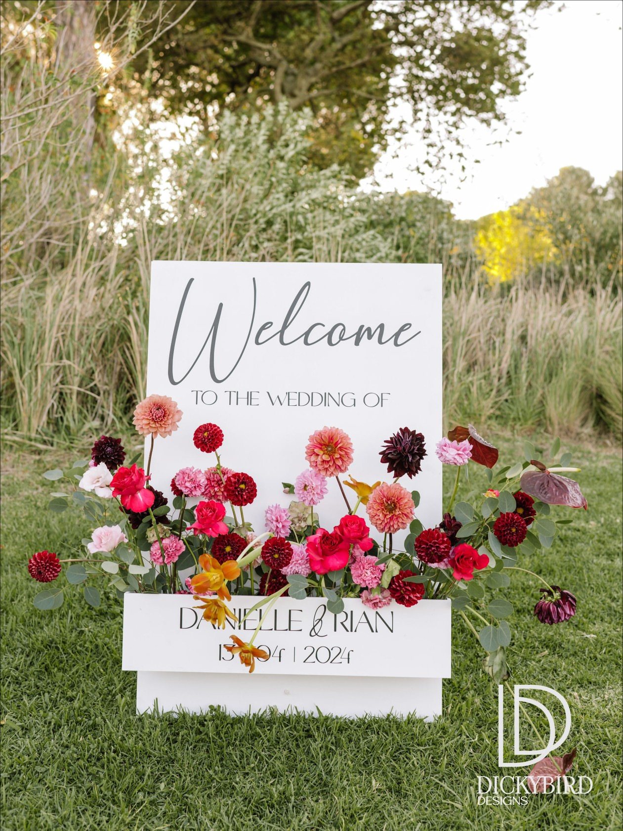 Wedding welcome sign with floral arrangement