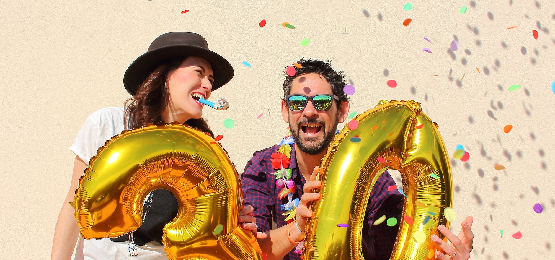 Gold number balloons with confetti at a celebration.