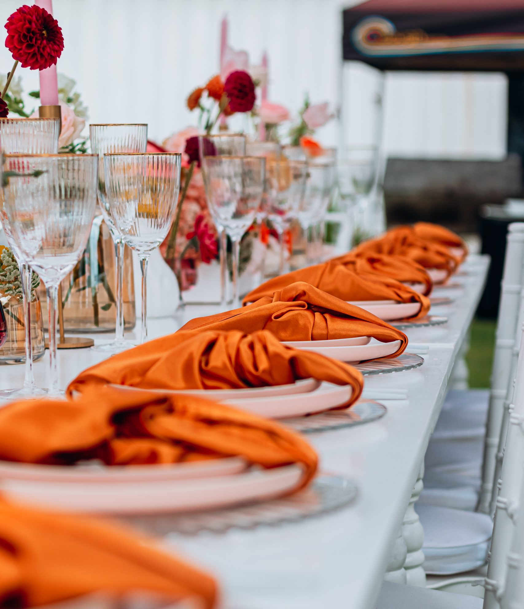 Table setting with orange napkins and glassware