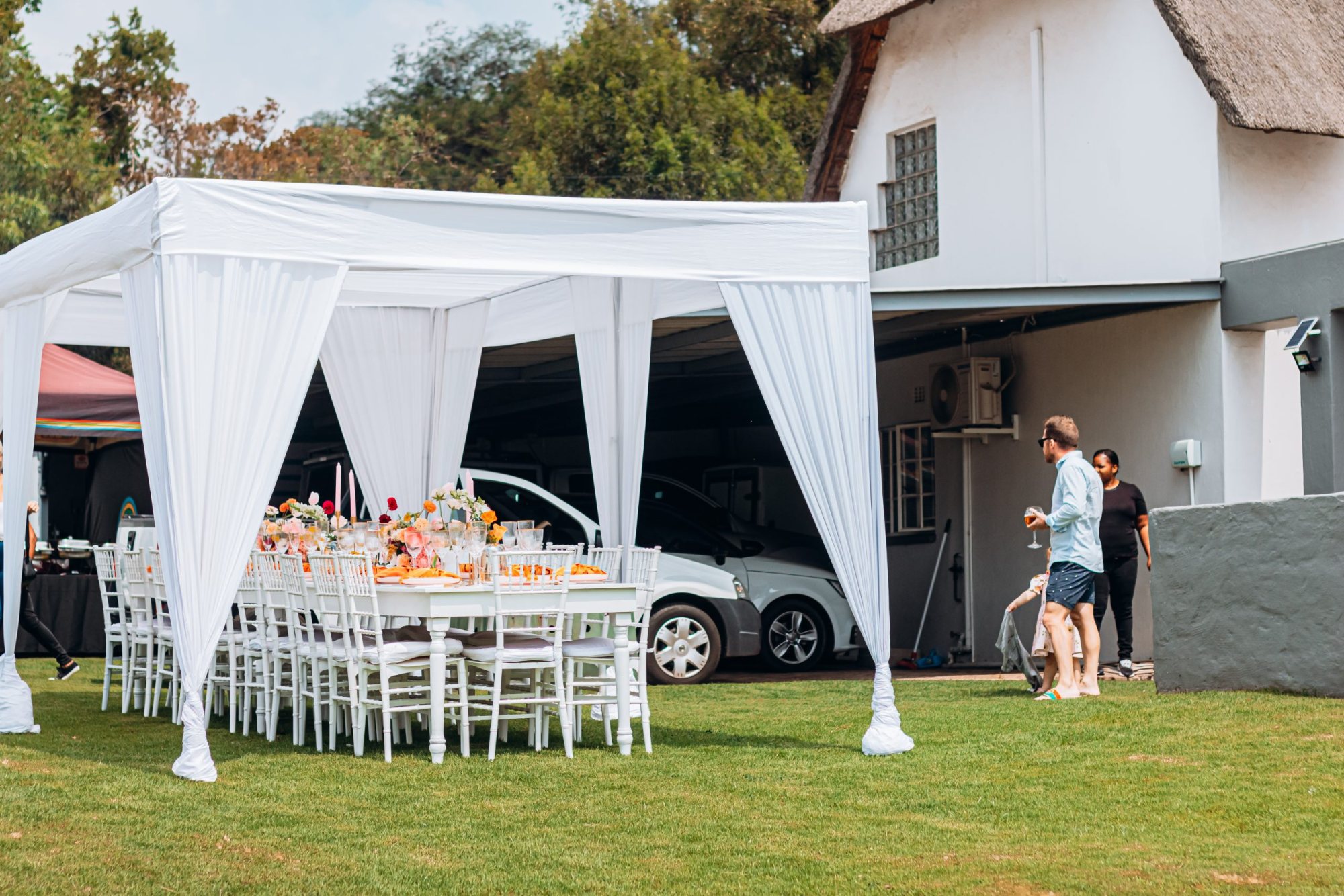 White canopy setup with chairs and table for outdoor event