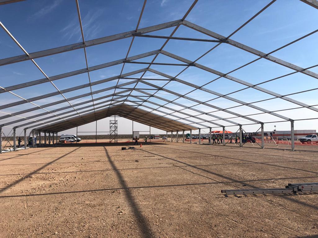 Large empty marquee structure under clear sky