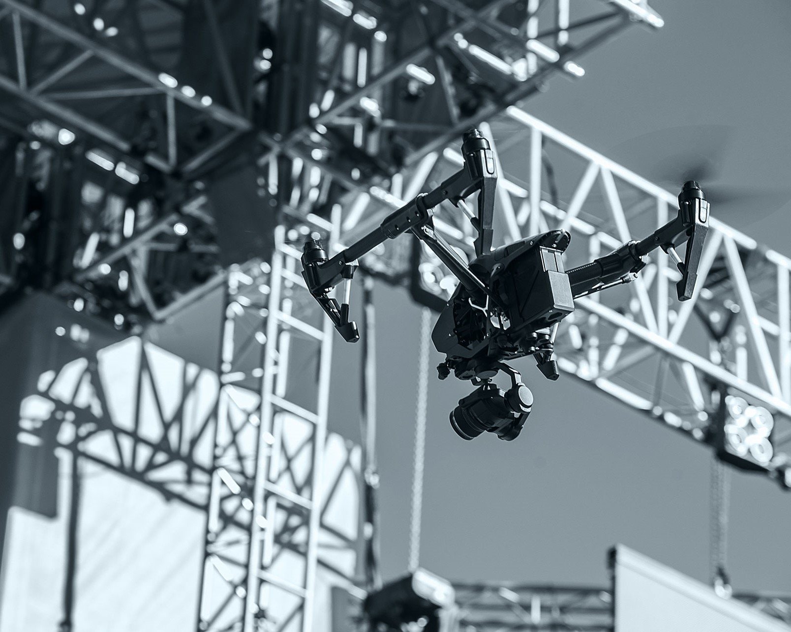 Drone flying near event staging structure
