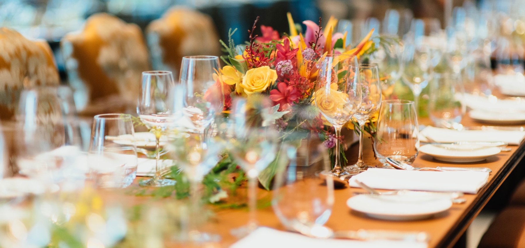 Tableware and flower arrangement for an event setup.