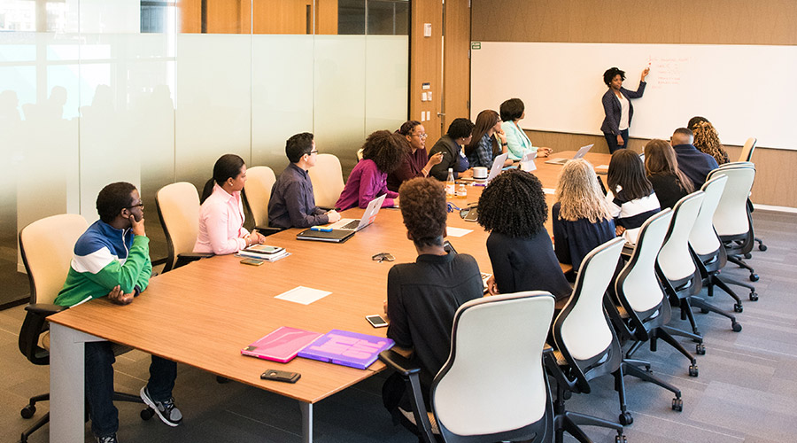 Conference room with a long table and chairs set up for a training session