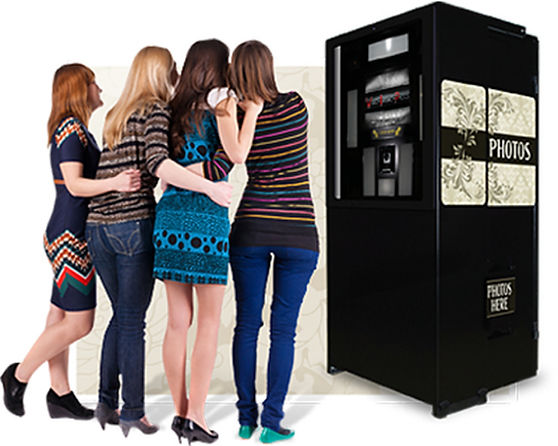 Four women in front of a photo booth