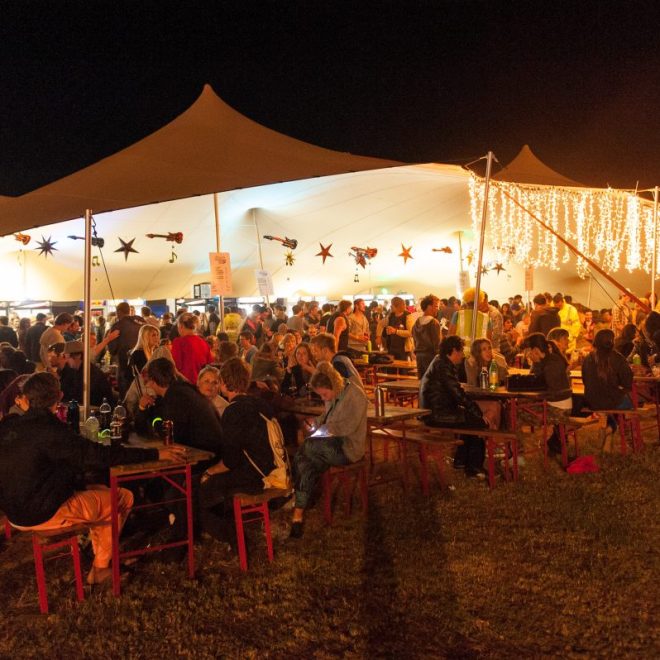 Crowd under a stretch tent during an outdoor event